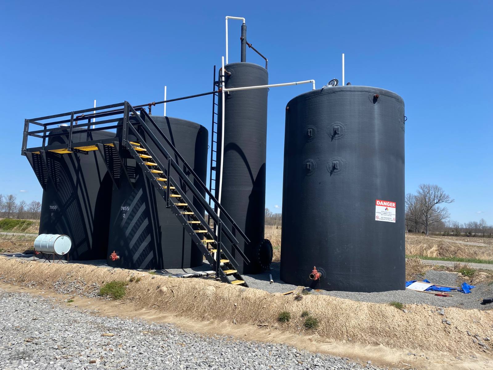 Fiberglass tank battery at a Norwood Energy production site